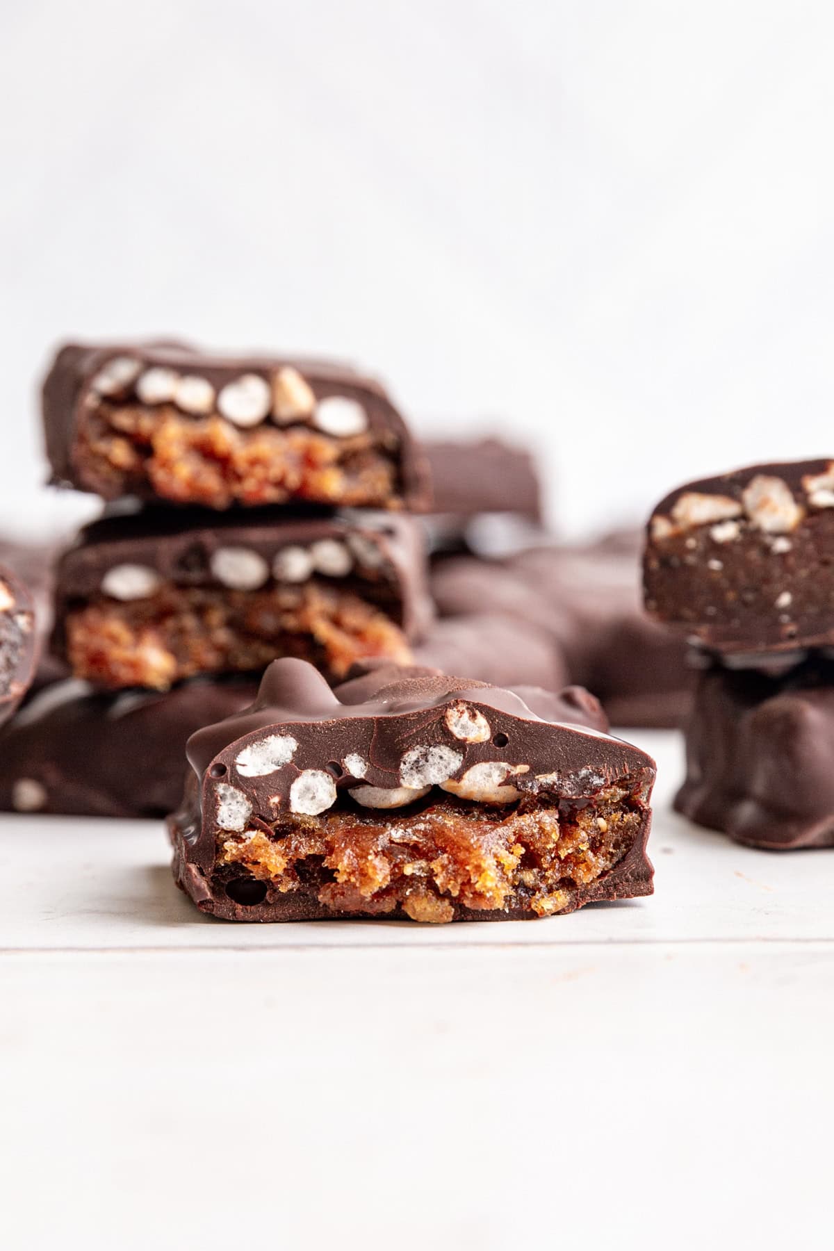 A vegan 100 grand bar broken in half to see the caramel and rice center.