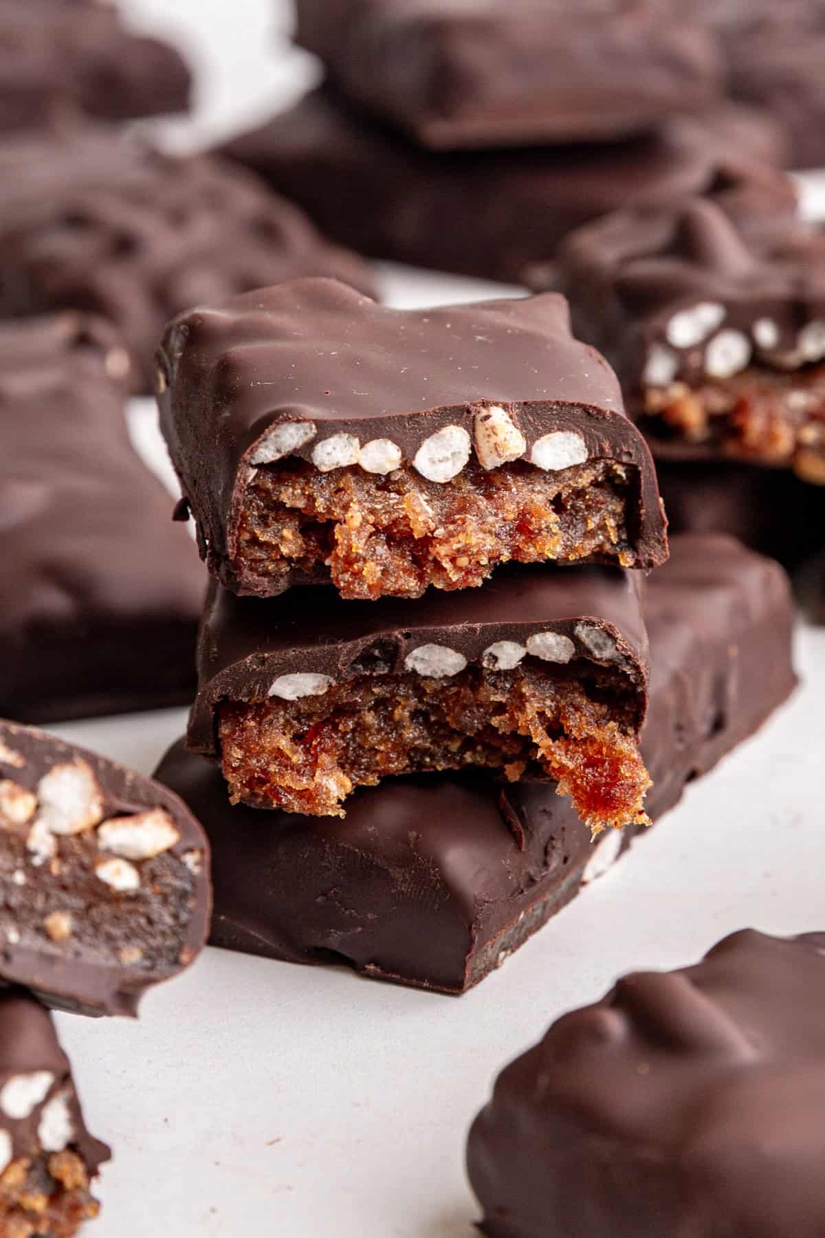 A vegan 100 grand bar broken in half to see the caramel and rice center.