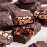 A vegan 100 grand bar broken in half to see the caramel and rice center.