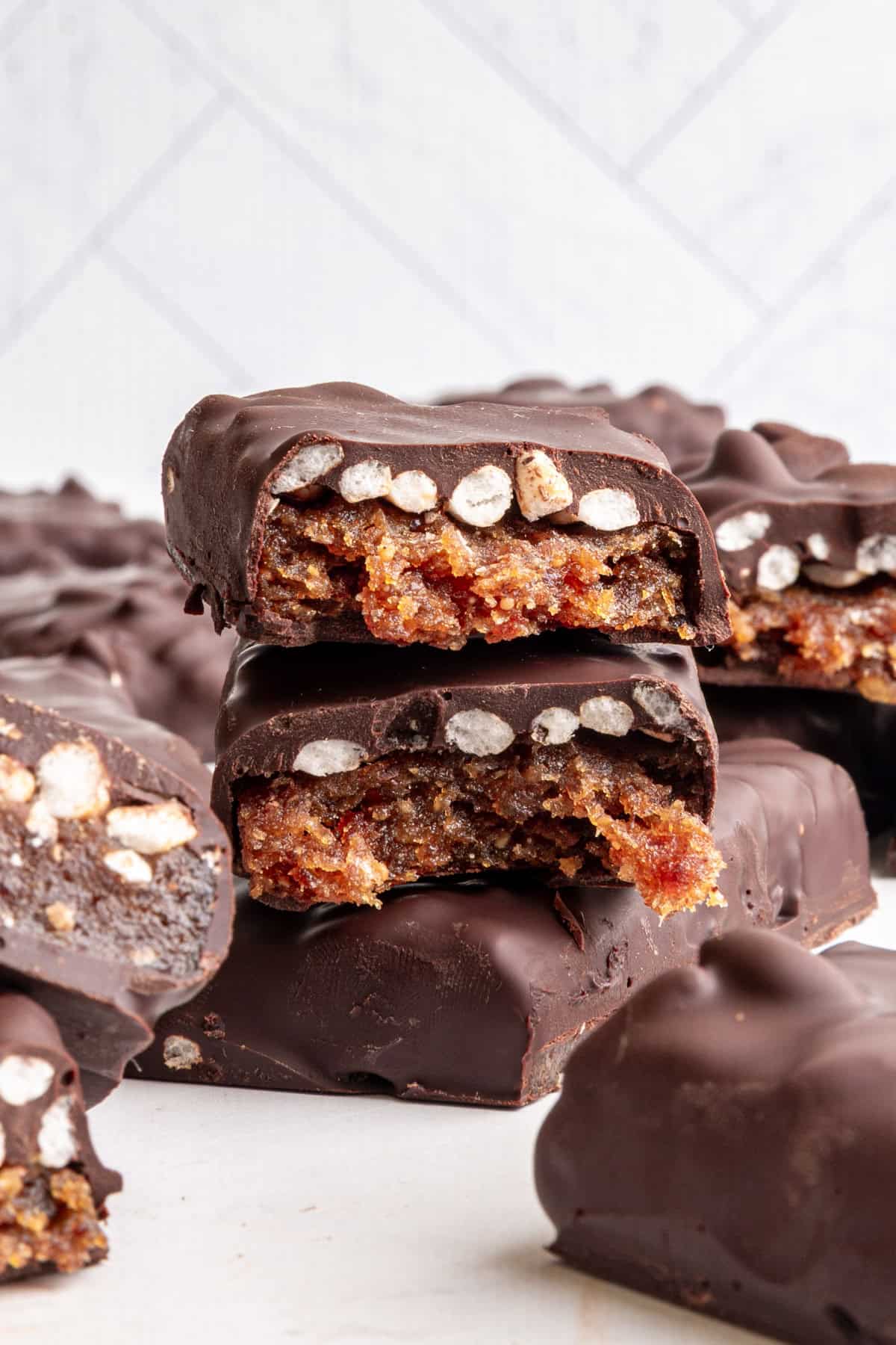 A vegan 100 grand bar broken in half to see the caramel and rice center.