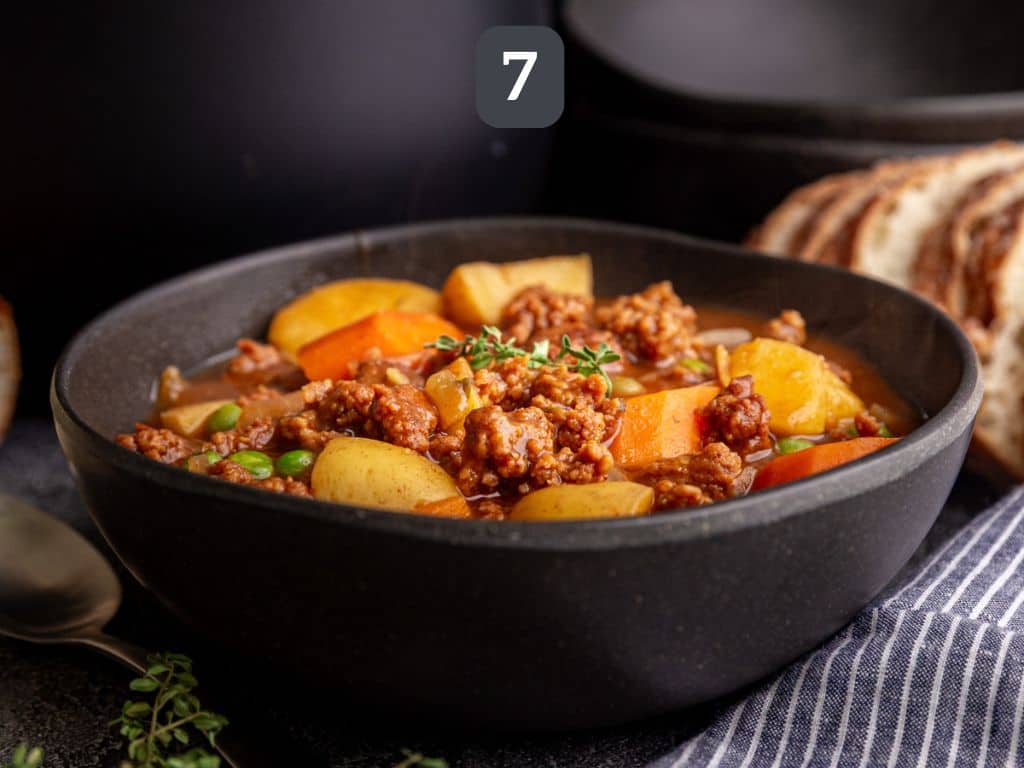 Vegan Chorizo Stew Step 7 - serve with thyme and bread.