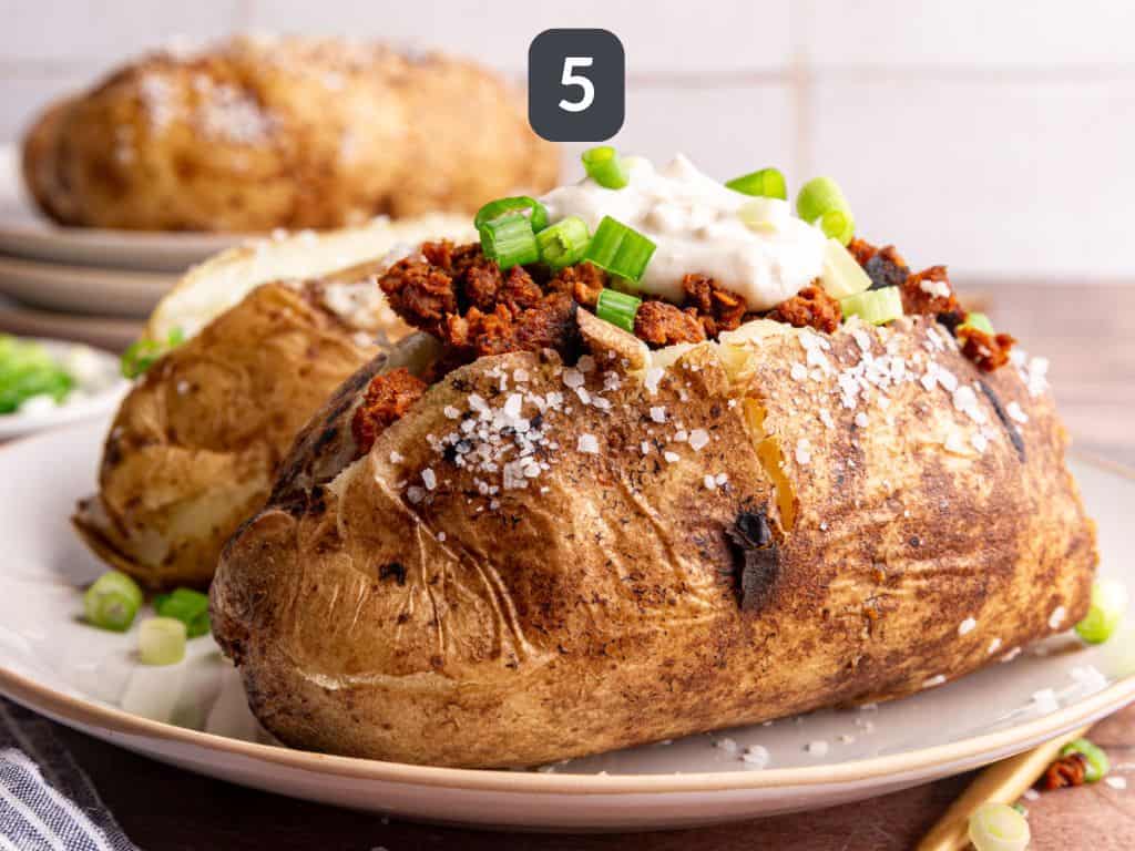 Vegan loaded baked potatoes step 5 - load with toppings.