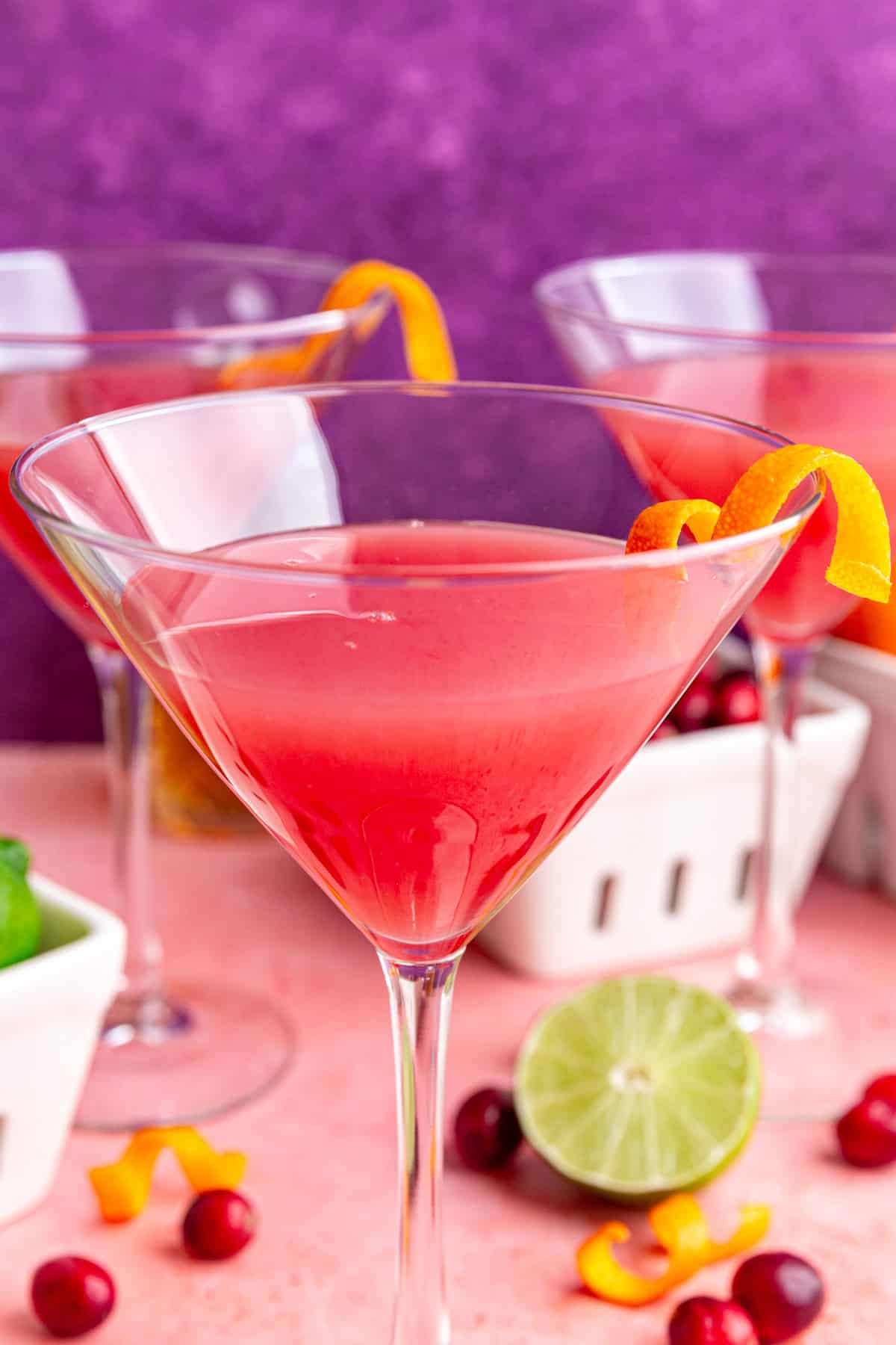 A cosmopolitan mocktail garnished with an orange twist.