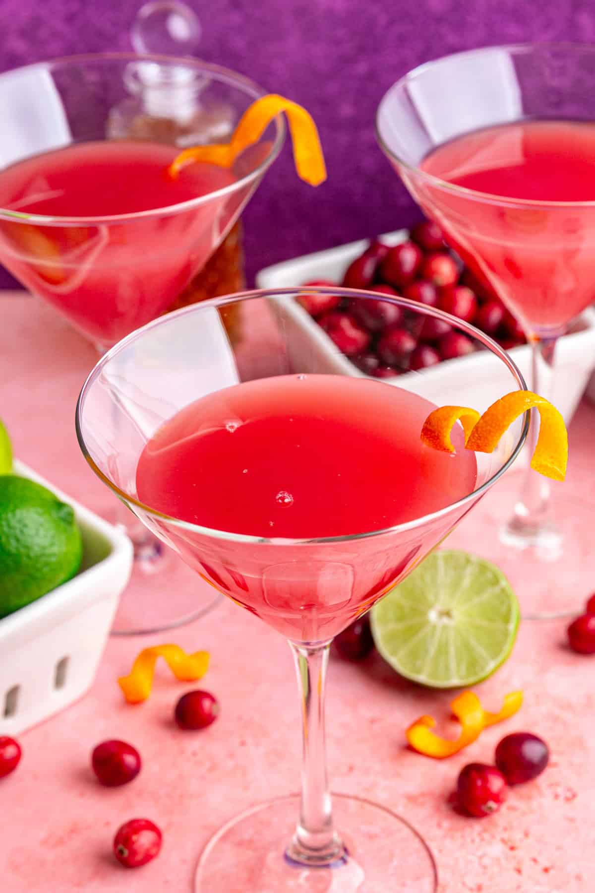 A cosmopolitan mocktail garnished with an orange twist.