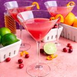 A cosmopolitan mocktail garnished with an orange twist.