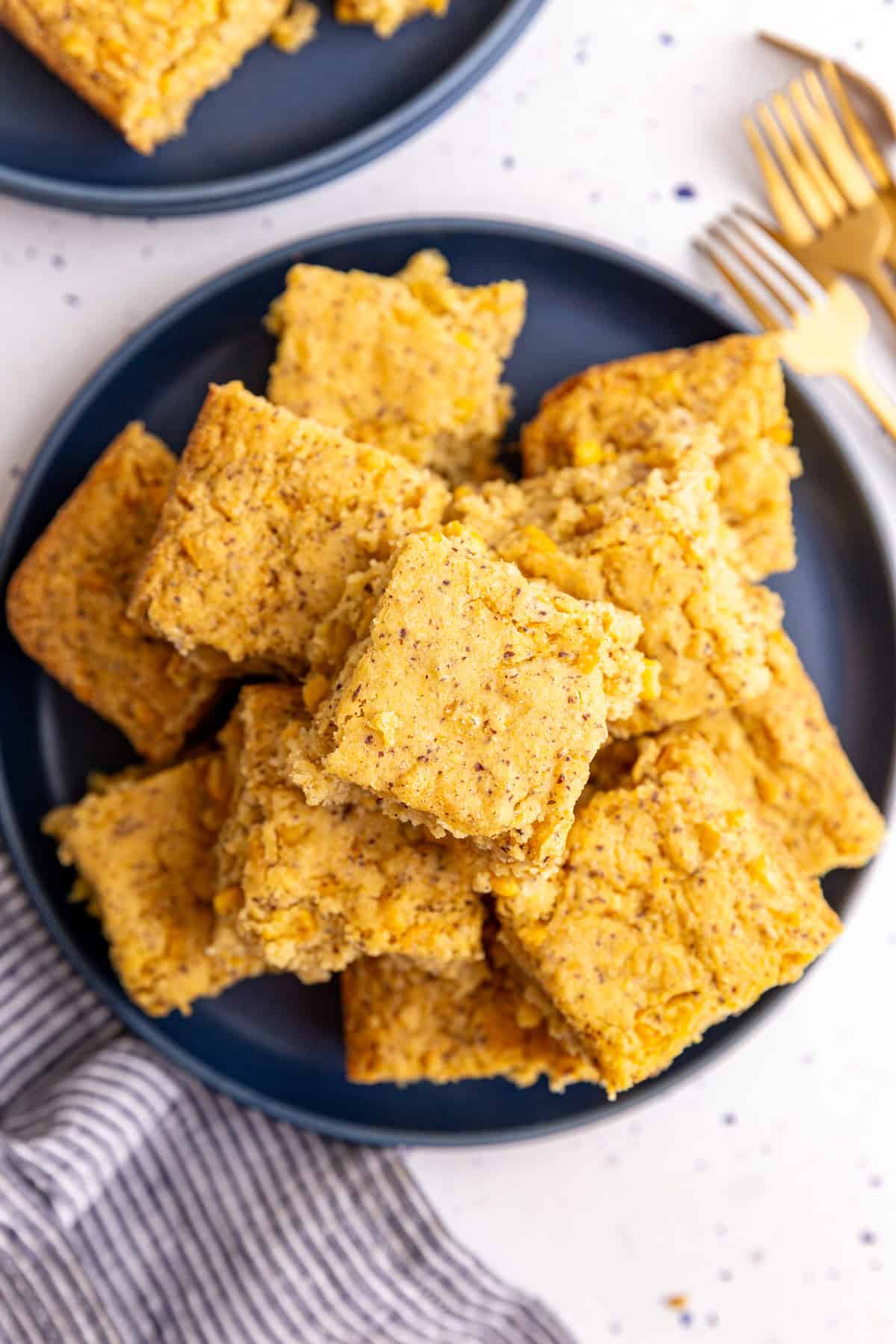 A plate with a stack of vegan cornbread casserole slices.