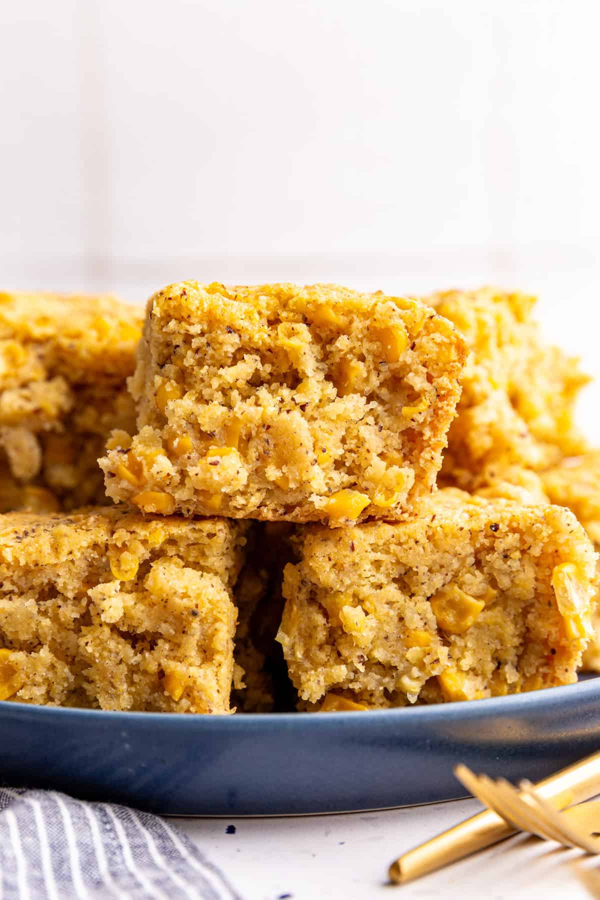 A plate with a stack of vegan cornbread casserole slices.