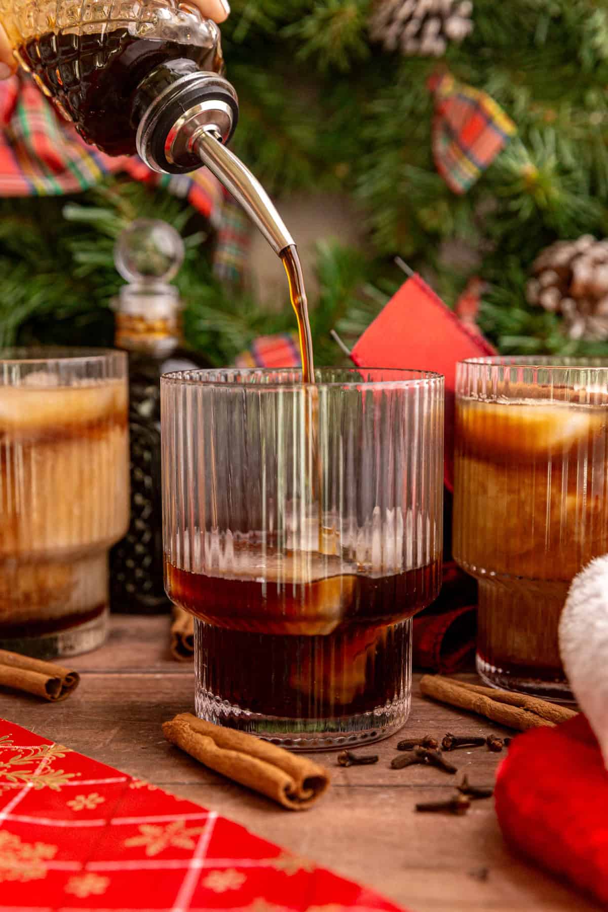 Gingerbread latte syrup, being poured into a gingerbread latte.