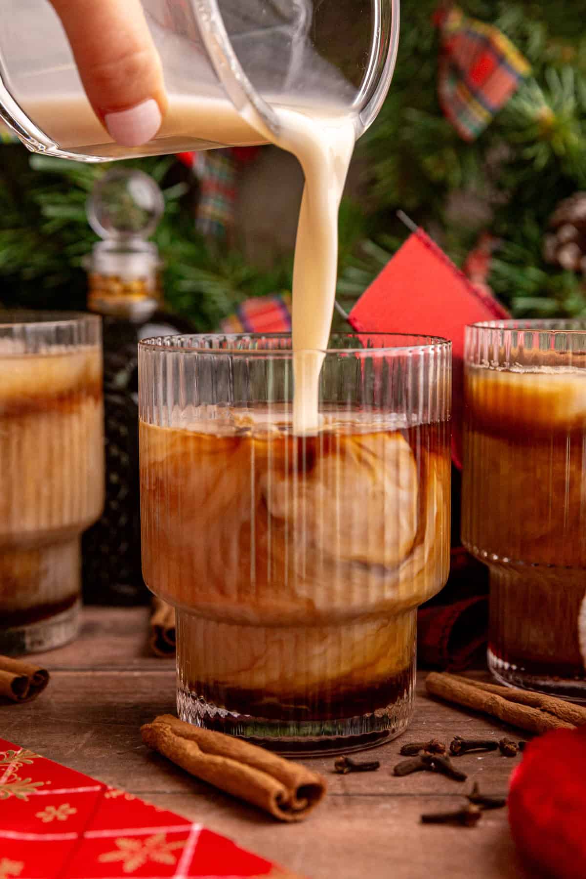 Pouring milk into a iced vegan gingerbread latte.