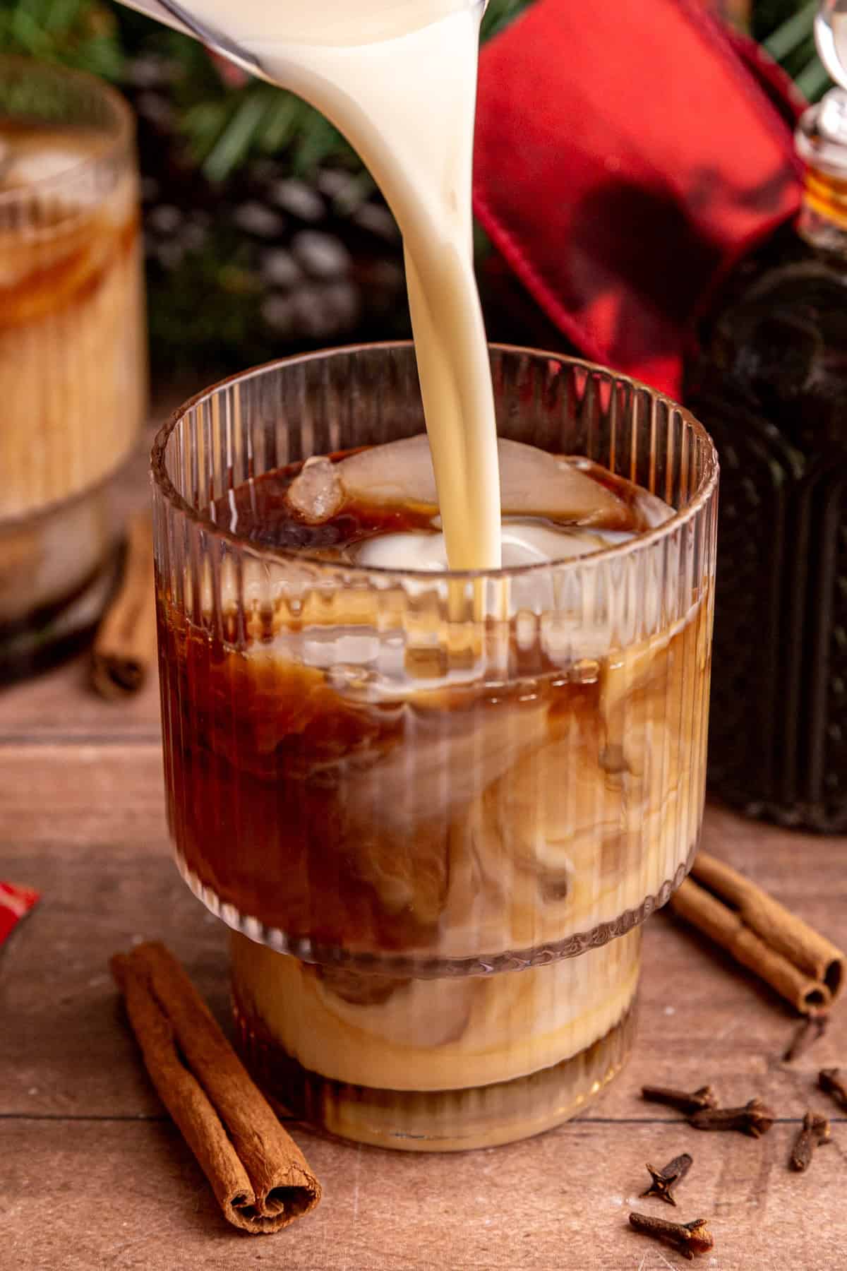 Pouring milk into a iced vegan gingerbread latte.