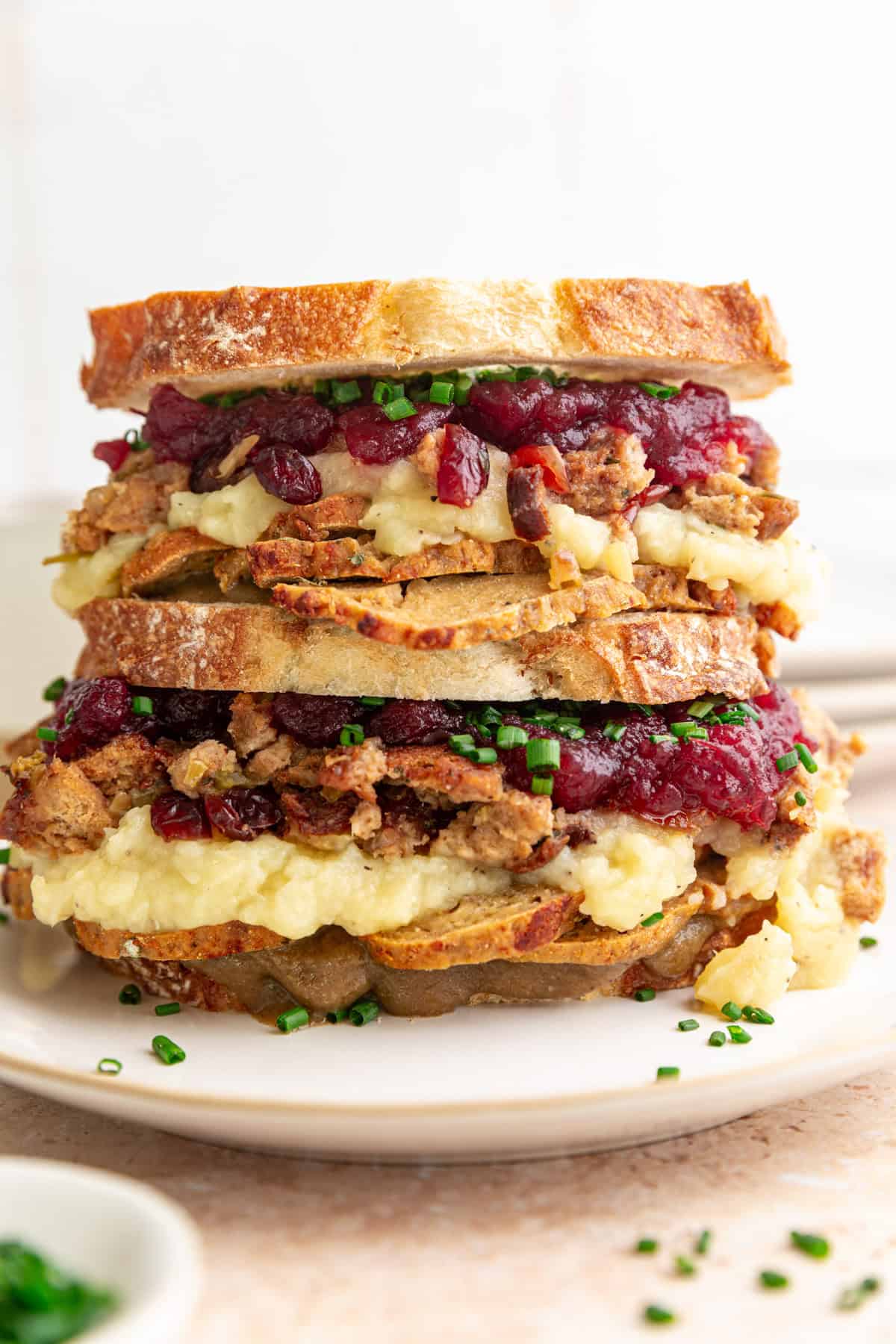 A double decker Vegan Thanksgiving Leftovers Sandwich.