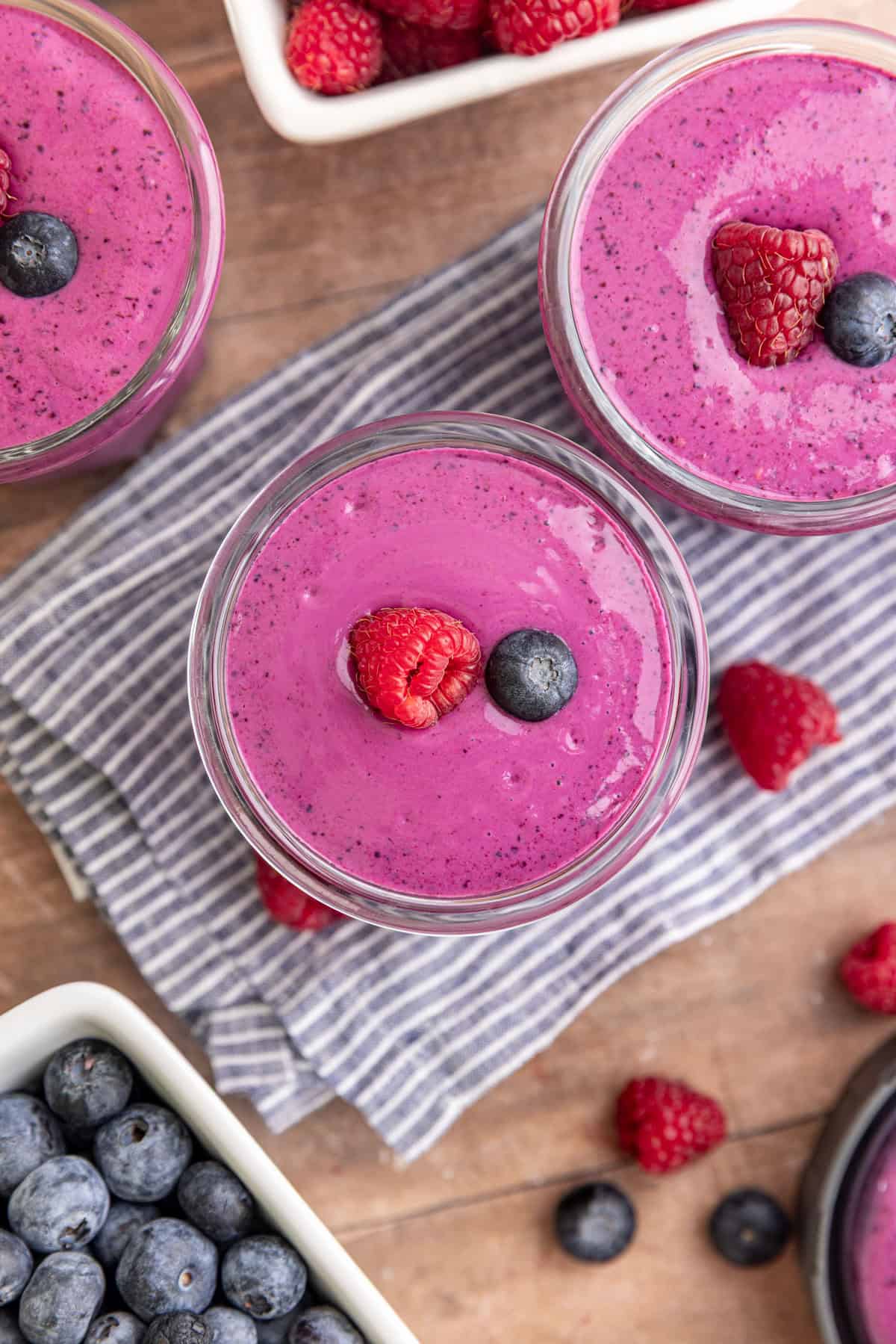 A top-down view of a Blueberry Raspberry Smoothie, garnished with a fresh raspberry and blueberry.