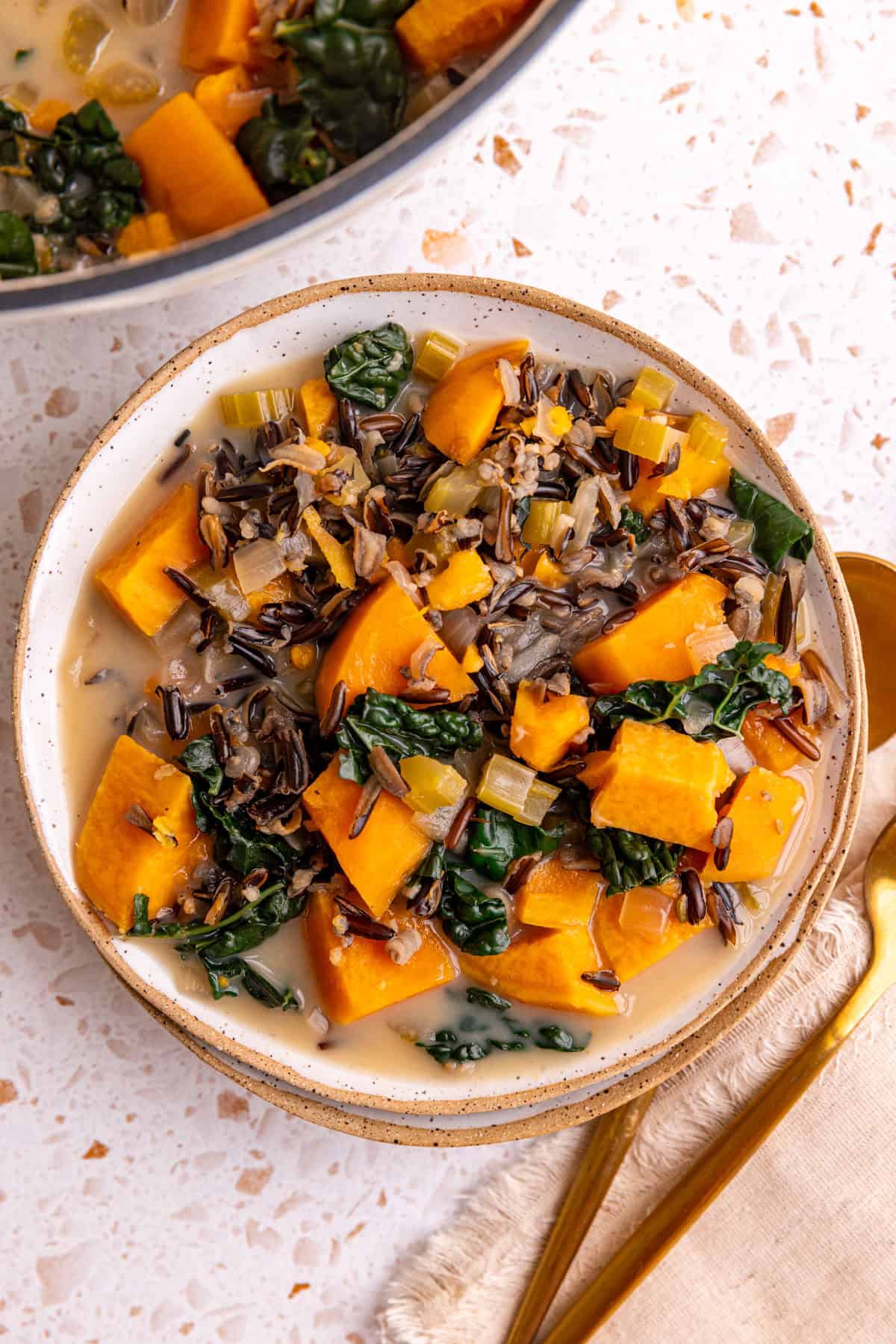 A bowl of sweet potato wild rice soup, ready to eat.