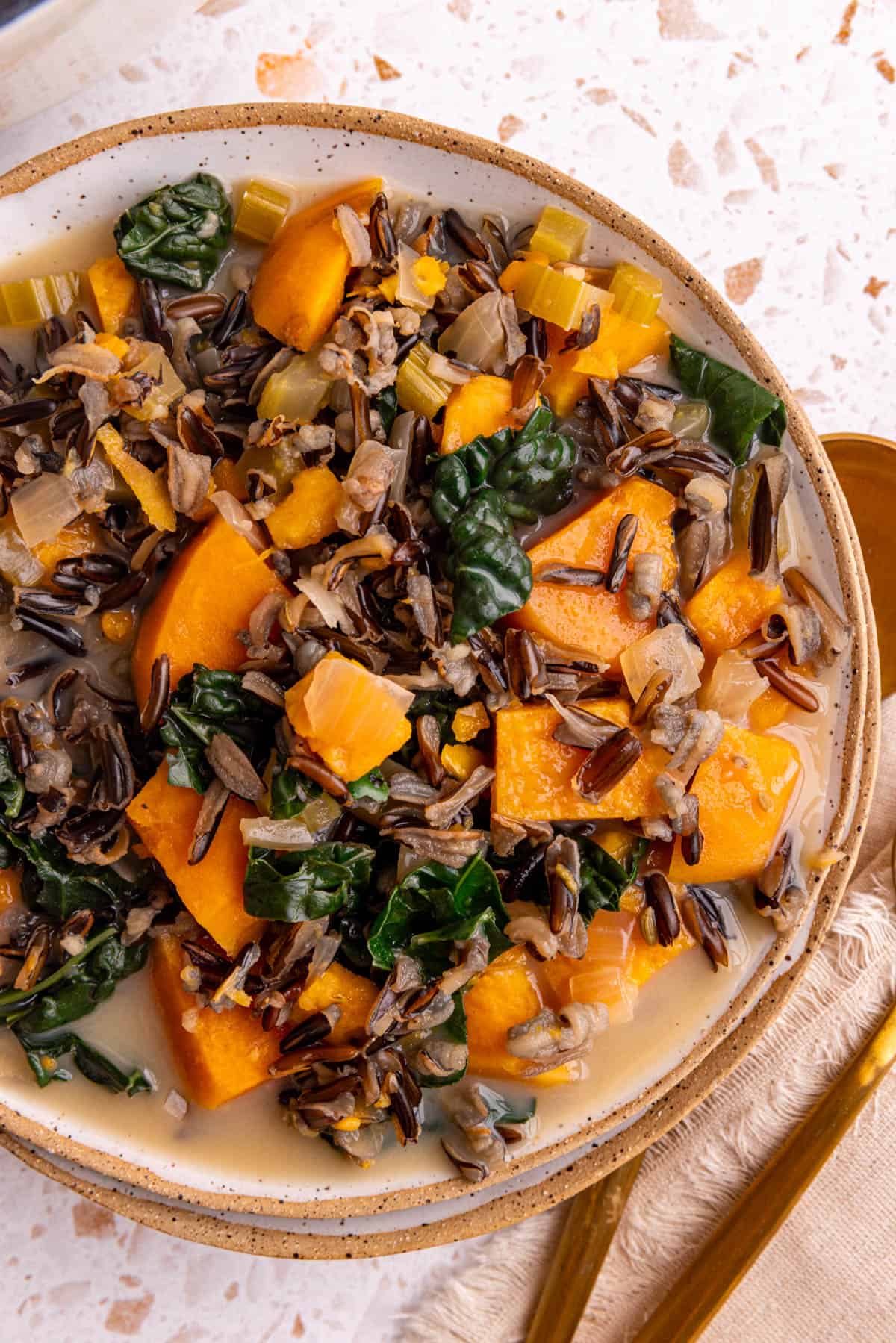 A bowl of sweet potato wild rice soup, ready to eat.