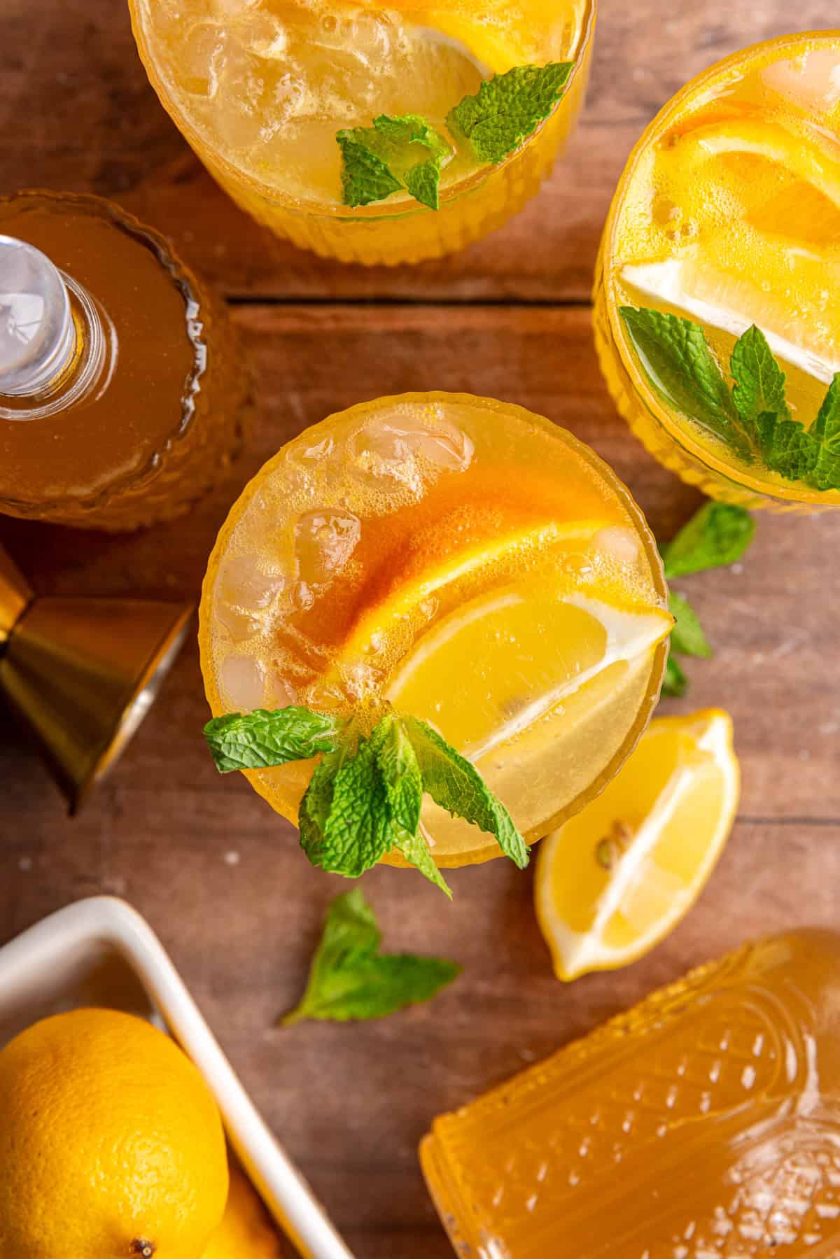 A top down view of the orange, lemon, and mint garnishes of a citrus mocktail.