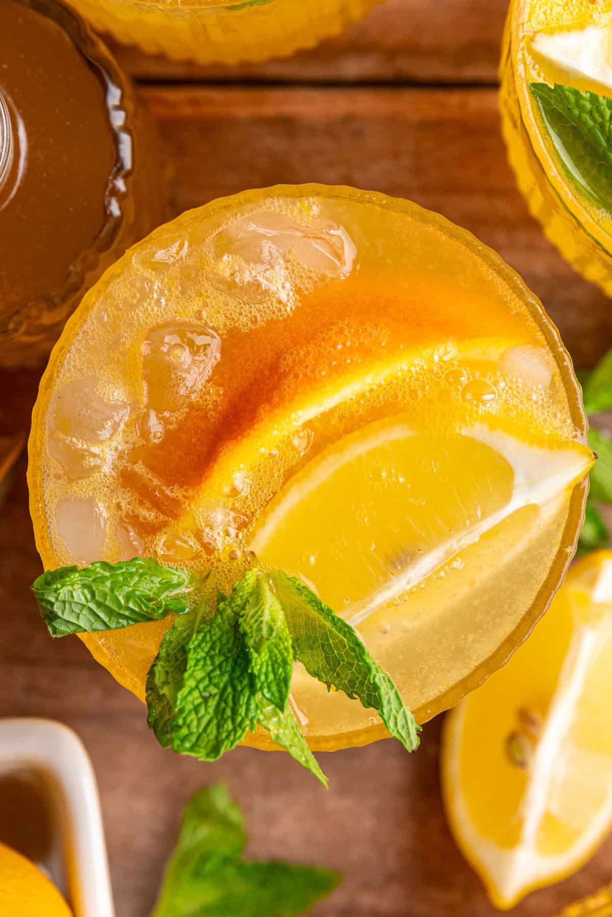 A top down view of the orange, lemon, and mint garnishes of a citrus mocktail.