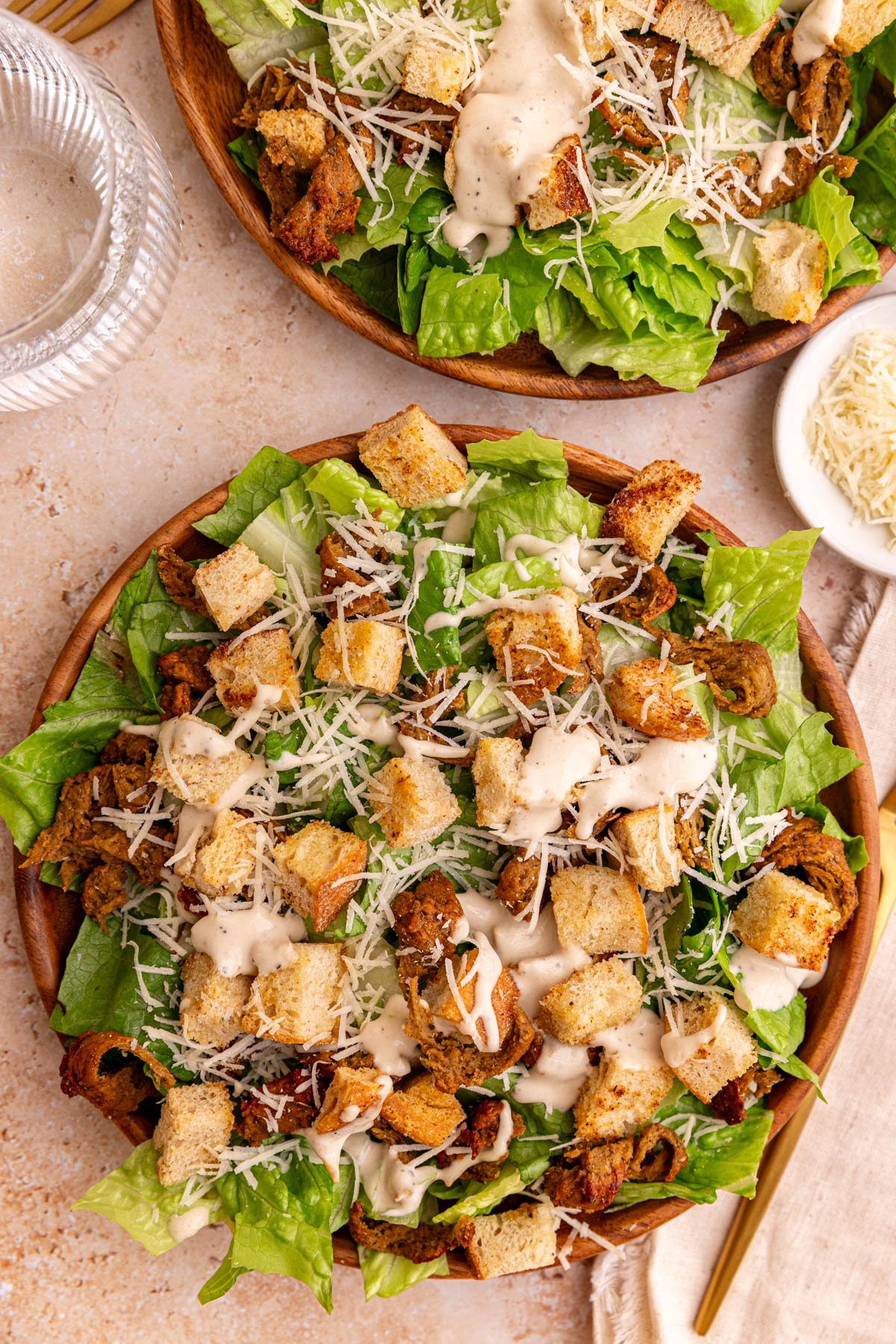 Two plates of vegan chicken caesar salad.