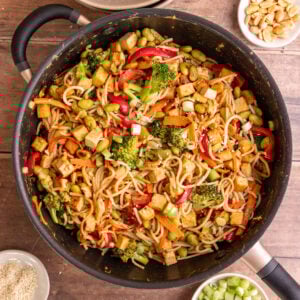 A skillet of freshly cooked vegan satay noodles.