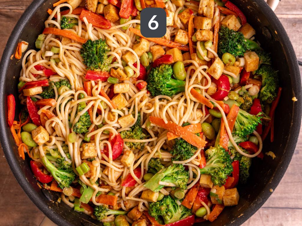 Vegan satay noodles step 6 - return the tofu to the pan, add the noodles, and remaining sauce.