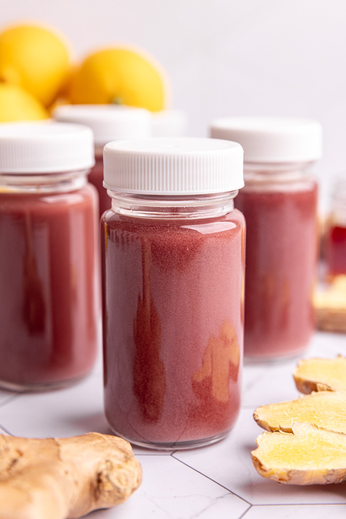 Homemade ginger elderberry shots in small juice shot glasses.