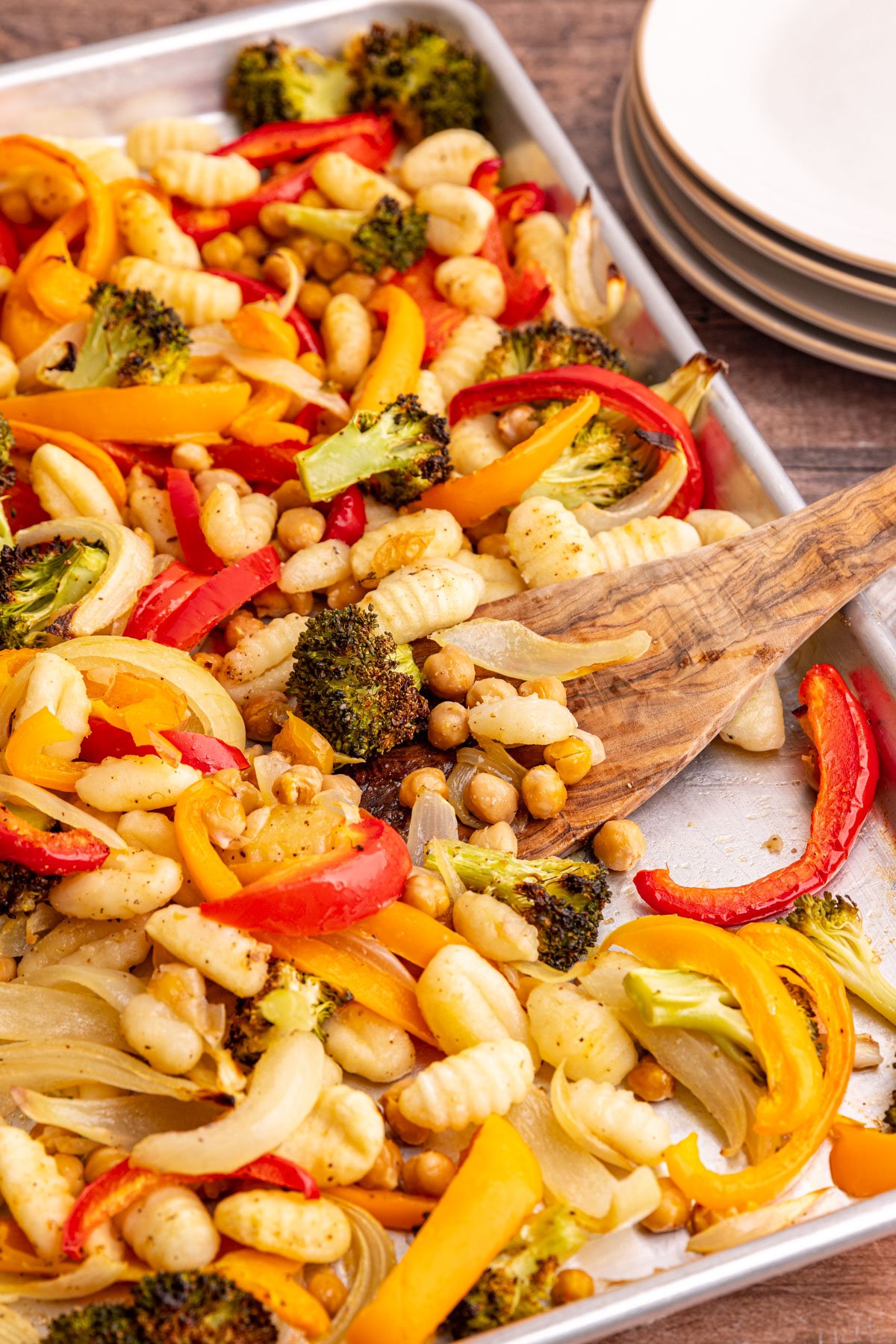 A sheet pan of freshly cooked gnocchi, chickpeas, and vegetables.