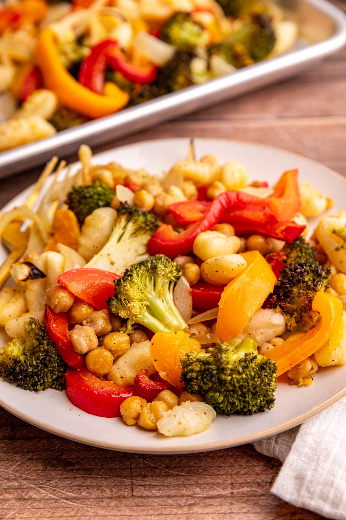 A plate of sheet pan gnocchi, vegetables, and chickpeas.