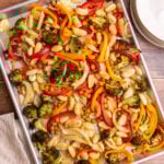 A sheet pan of freshly cooked gnocchi, chickpeas, and vegetables.