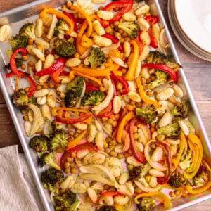 A sheet pan of freshly cooked gnocchi, chickpeas, and vegetables.