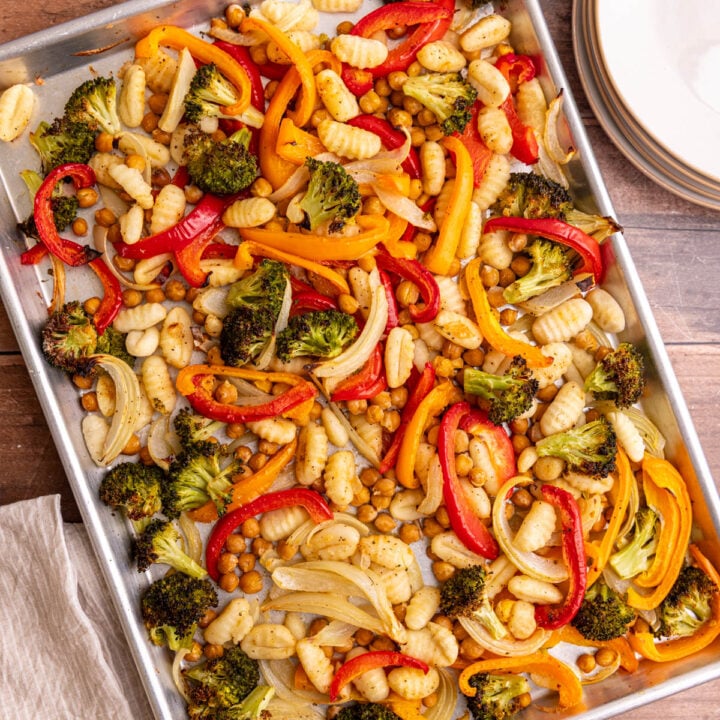 A sheet pan of freshly cooked gnocchi, chickpeas, and vegetables.