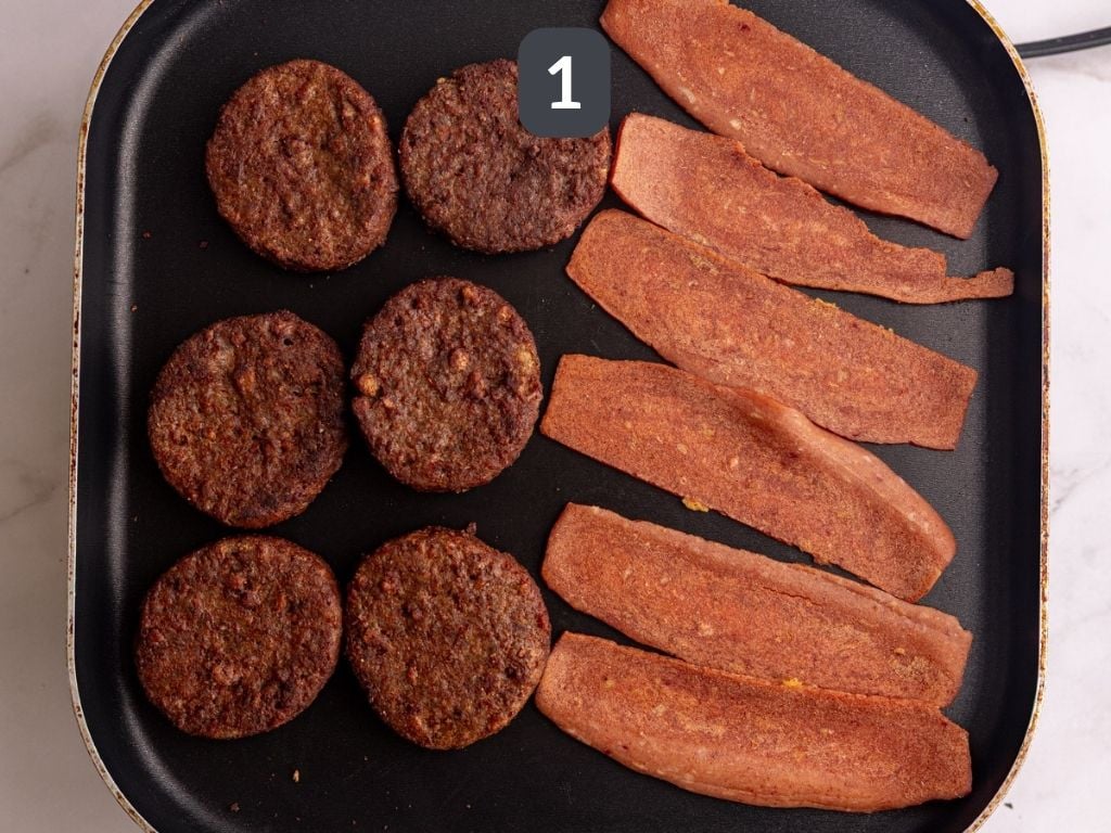 Vegan bagel breakfast sandwich step 1 - cook the bacon and sausage.