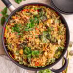 A pan of freshly cooked vegan drunken noodles, garnished with basil.