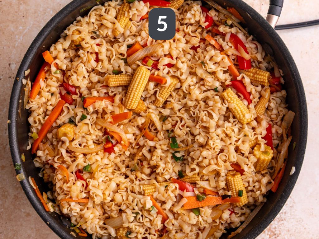 Vegan drunken noodles step 5 - add the noodles and sauce.