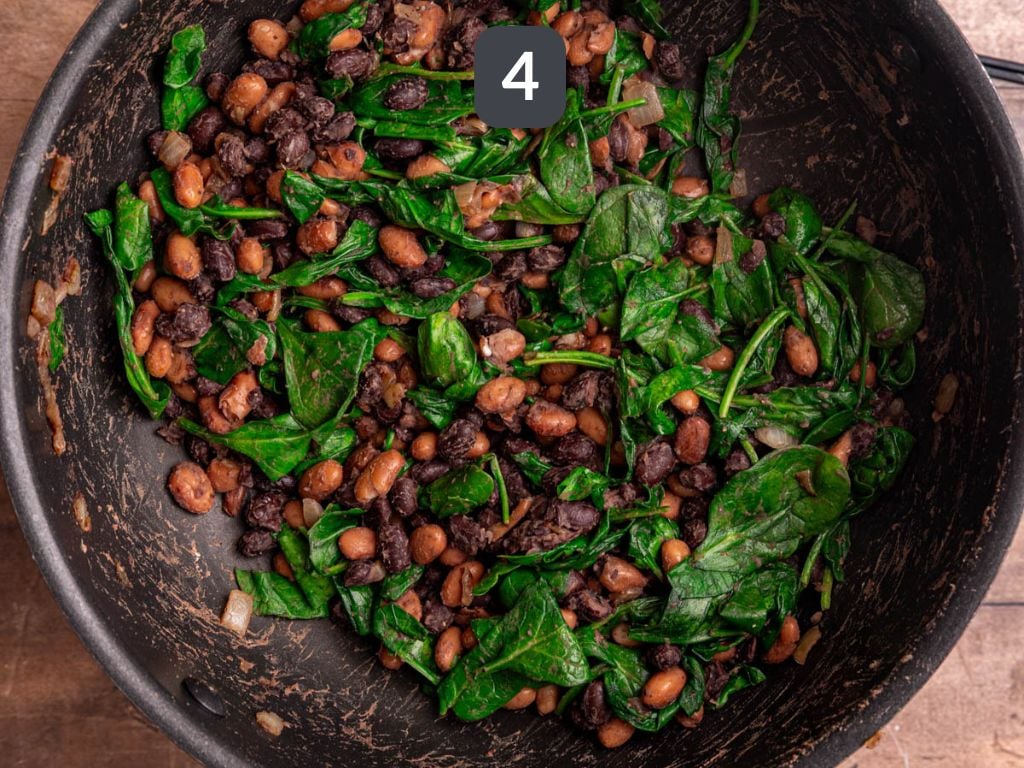 Vegan rice and bean enchiladas step 4 - add the beans and spinach.