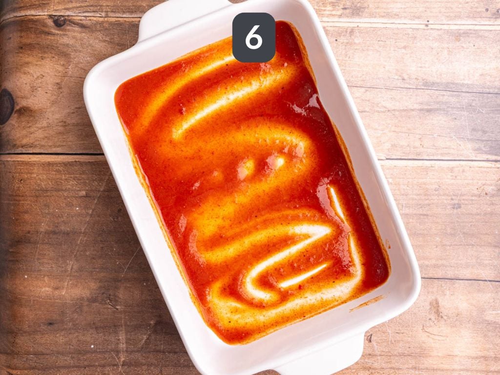 Vegan rice and bean enchiladas step 6 - coat the bottom of the pan with enchilada sauce.