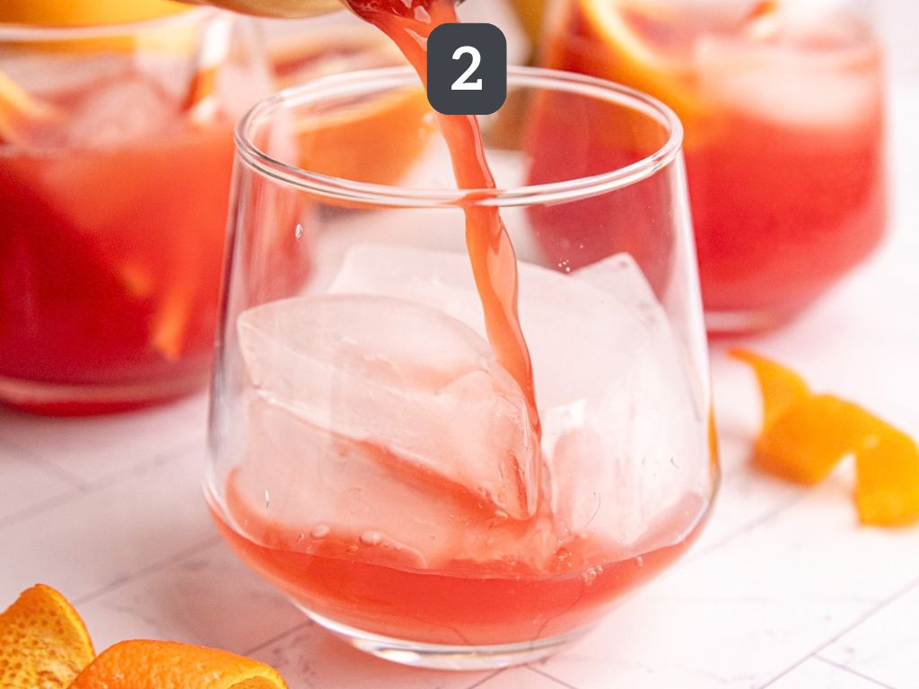 Aperol spritz mocktail step 2 - pour over ice
