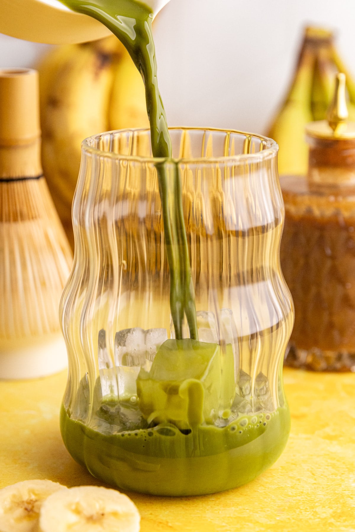 Matcha being poured into a glass.