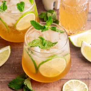 A ginger mojito mocktail, garnished with fresh mint and lime slices.