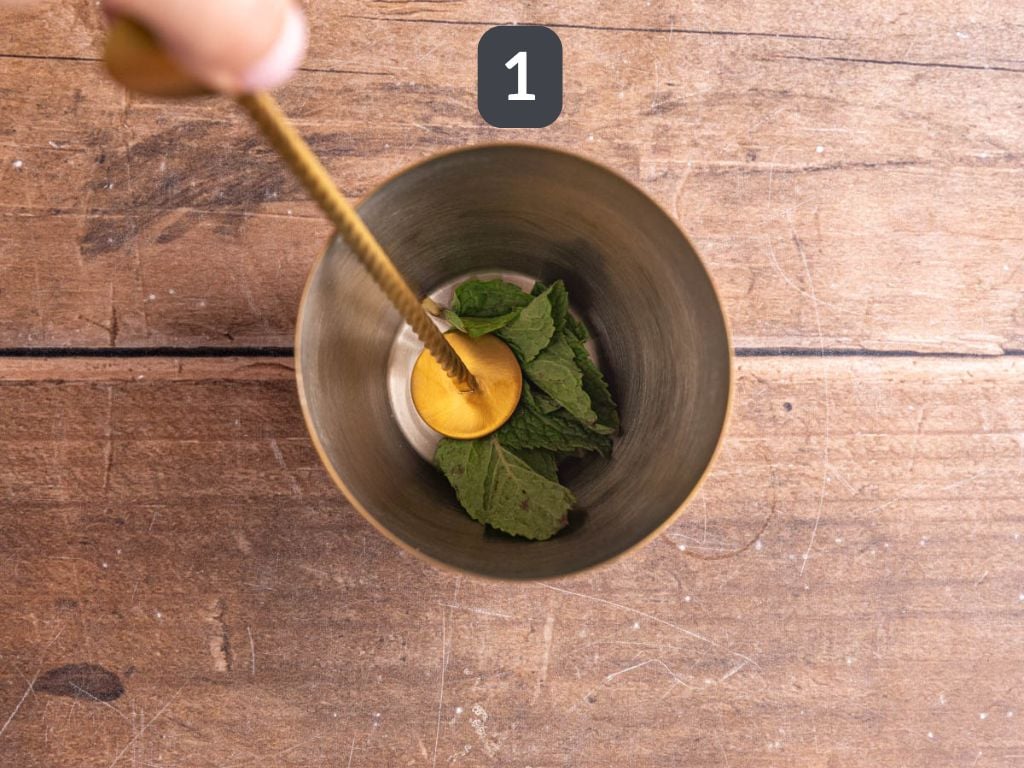 Ginger Mojito Mocktail Step 1 - muddle the mint