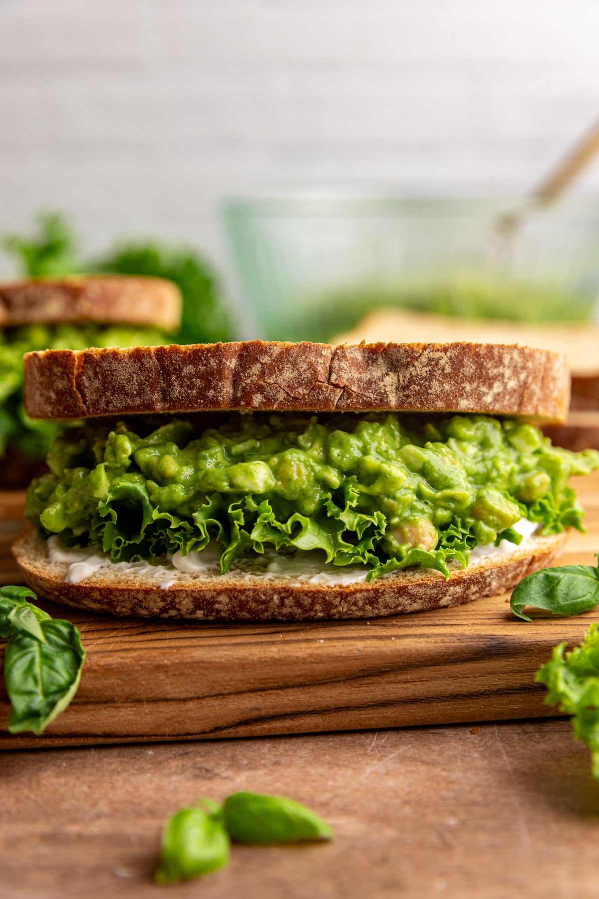 A green goddess chickpea salad sandwich, with lettuce and mayo.