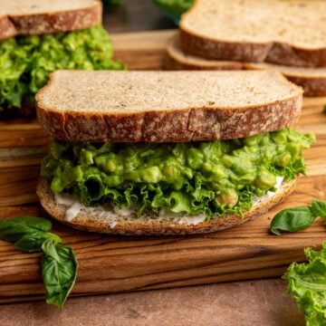 A green goddess chickpea salad sandwich, with lettuce and mayo.