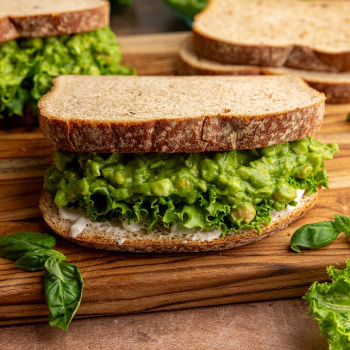 A green goddess chickpea salad sandwich, with lettuce and mayo.
