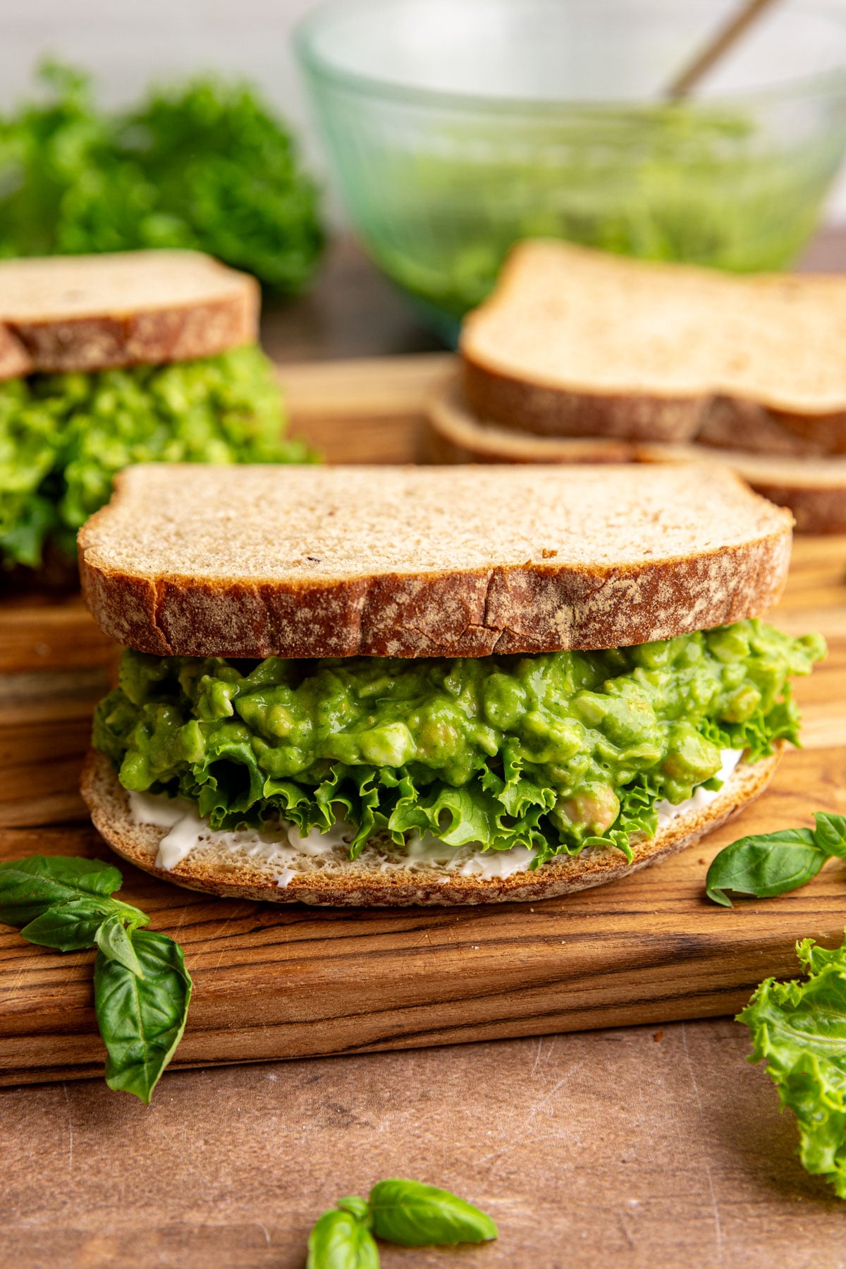A green goddess chickpea salad sandwich, with lettuce and mayo.