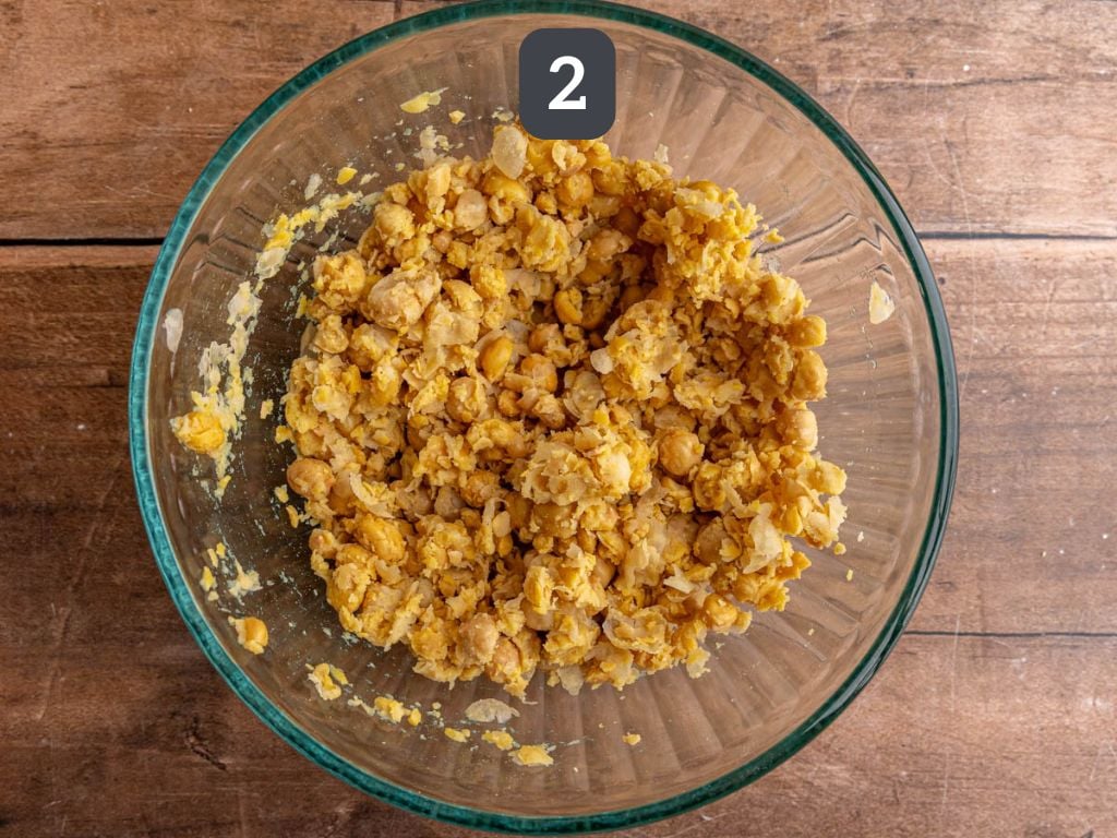 Green goddess chickpea salad step 2 - mash the chickpeas.