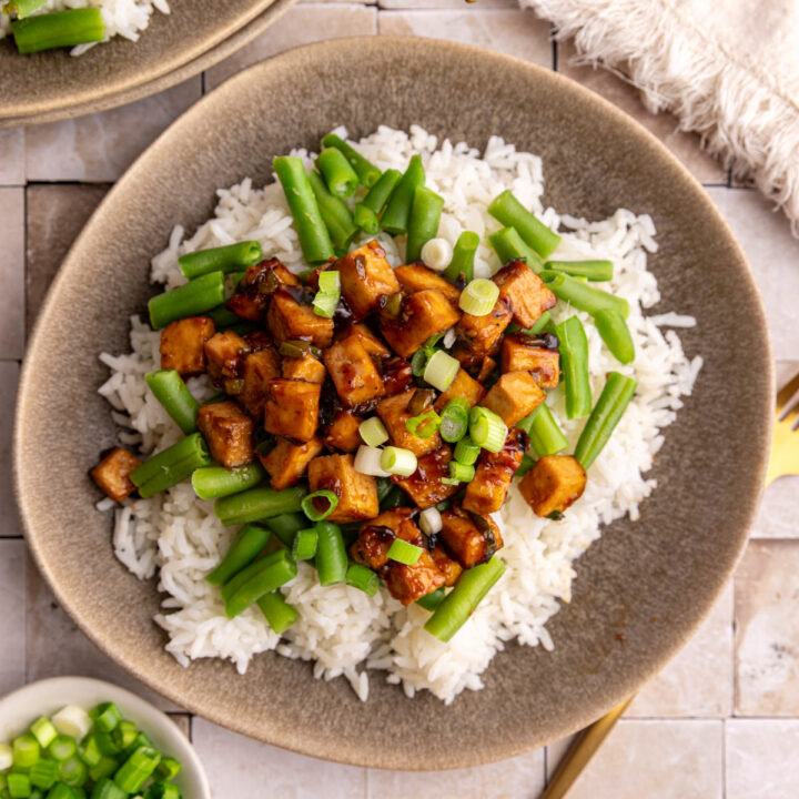 A plate of rice, Mongolian tofu, and green beans.