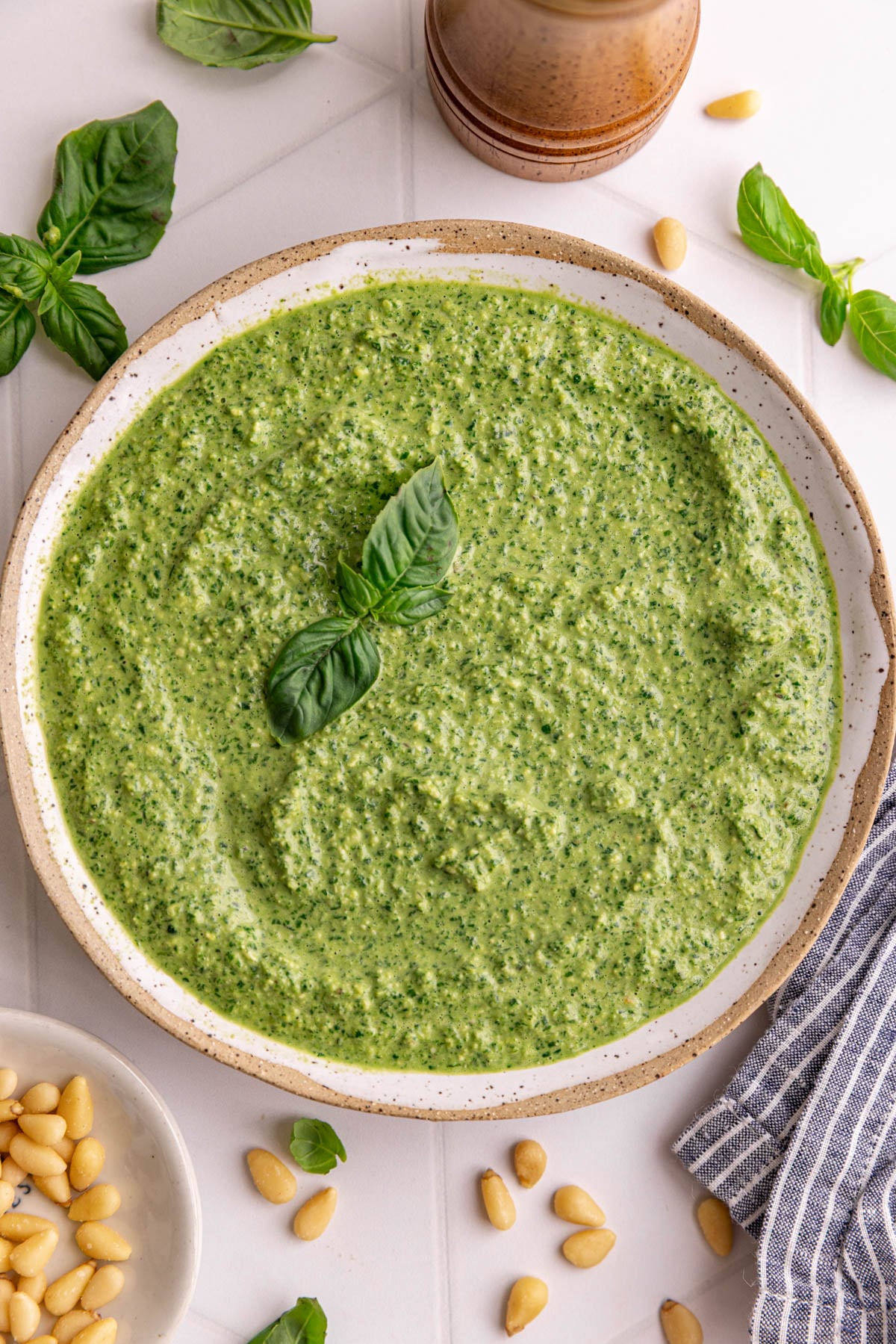 A bowl of vegan oil free pesto, garnished with a basil leaf.