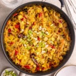 A pan of freshly cooked vegan Singapore noodles with tofu.