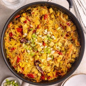 A pan of freshly cooked vegan Singapore noodles with tofu.