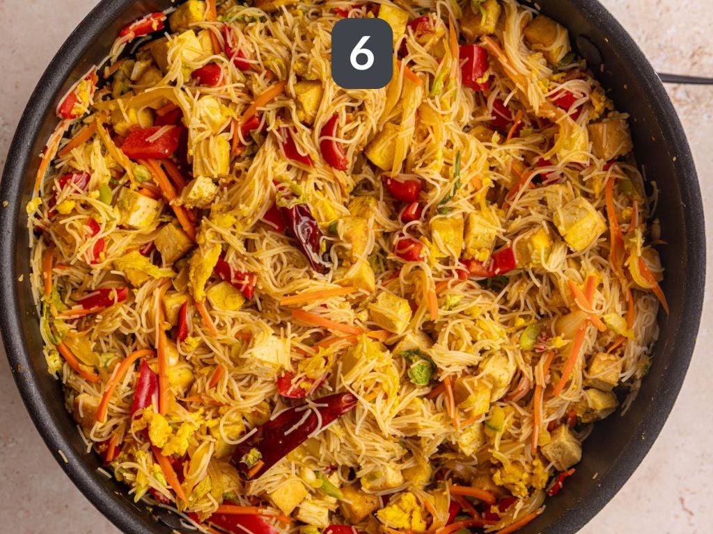 Vegan Singapore Noodles Step 6 - add the tofu, egg, noodles, and sauce to the pan.