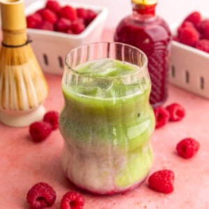 An iced raspberry matcha latte, stirred.