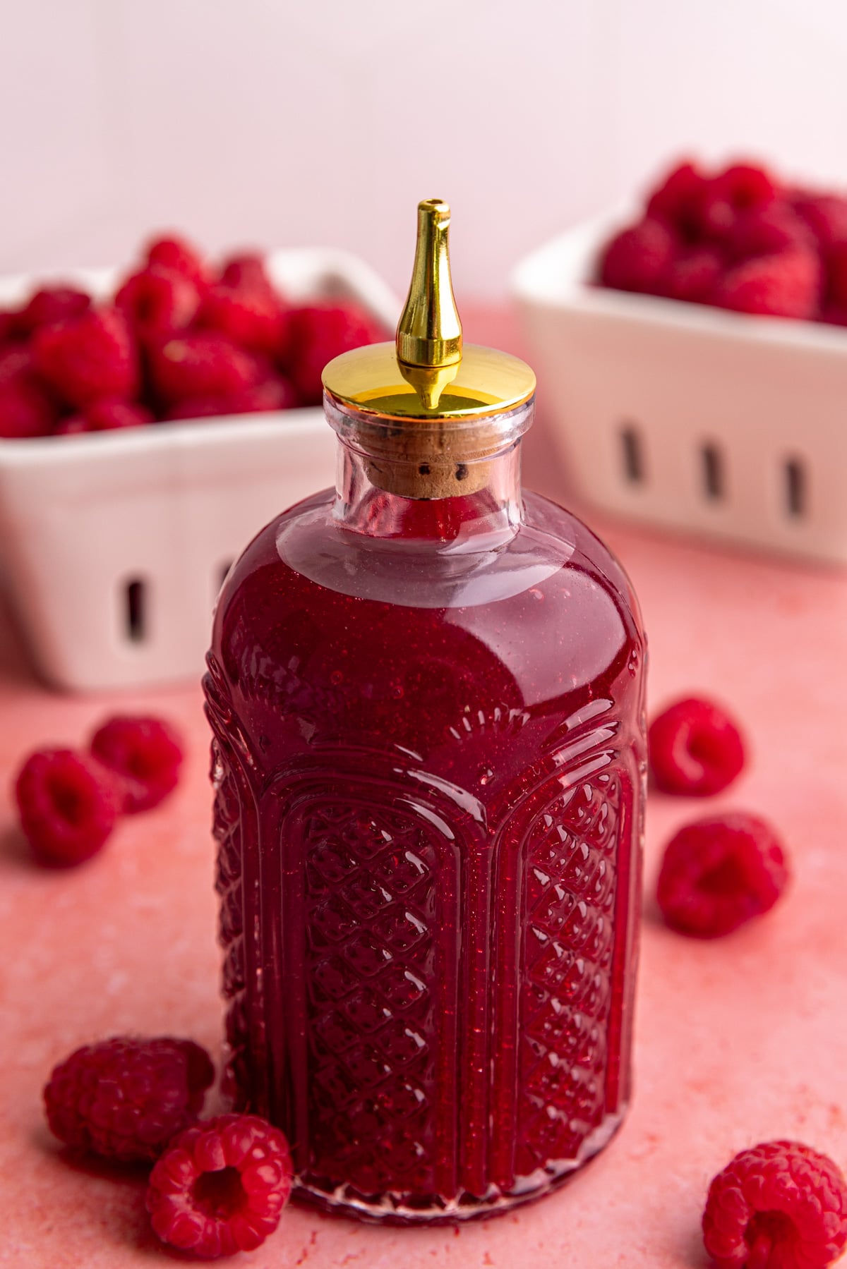 A bottle of raspberry simple syrup.